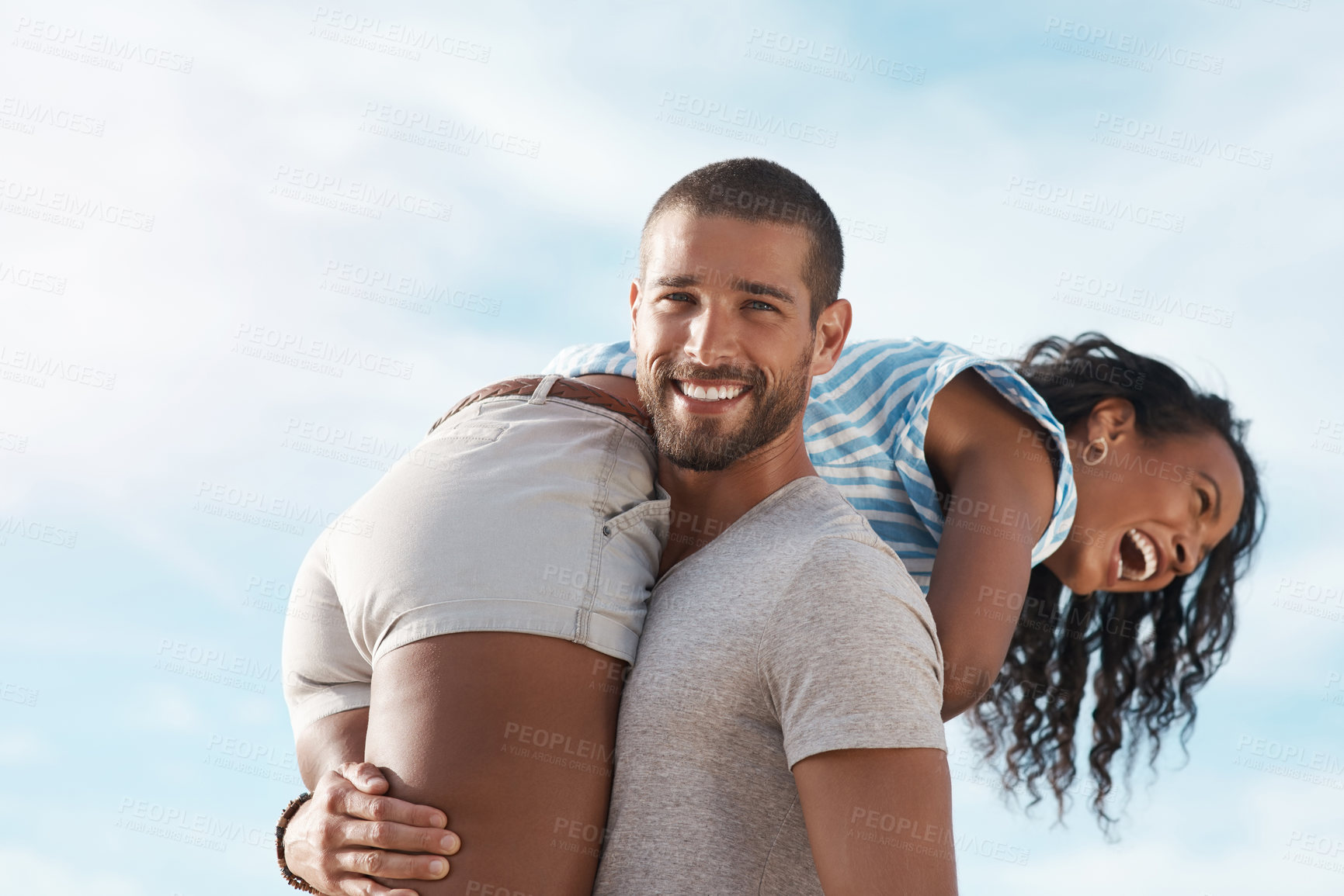 Buy stock photo Couple, portrait and carrying at beach for travel, summer and tropical holiday together in San Diego. Man, woman and playful on sand by ocean for adventure, love and relax on vacation with happiness