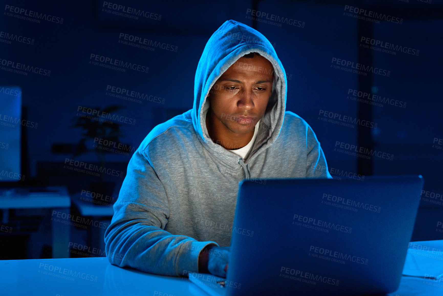 Buy stock photo Black man, hoodie or hacker with laptop for cybercrime, malware or phishing for stealing online. Programmer, night or typing software update on technology with hacking expert writing algorithm system