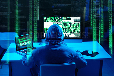 Buy stock photo Rearview shot of a male hacker cracking a computer code in the dark