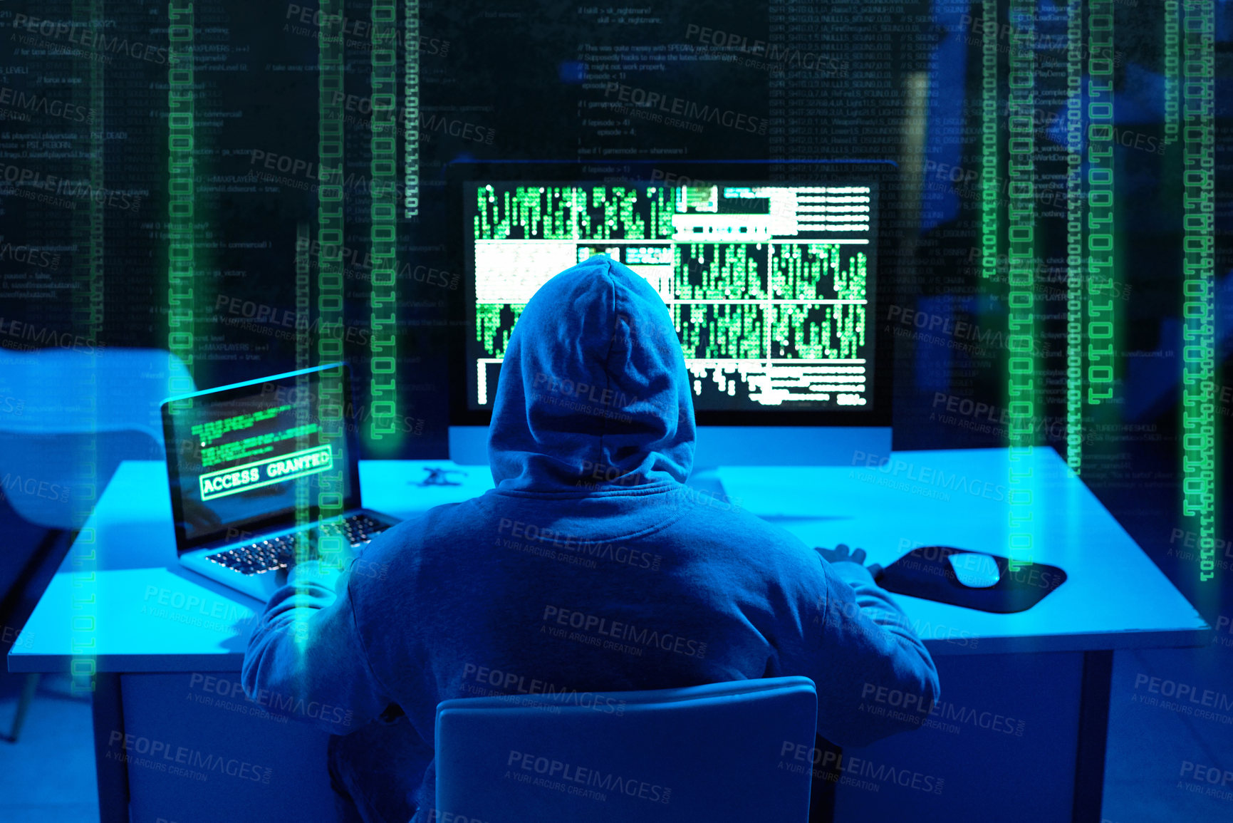 Buy stock photo Rearview shot of a male hacker cracking a computer code in the dark