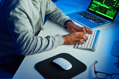 Buy stock photo Shot of an unrecognizable hacker cracking a computer code in the dark