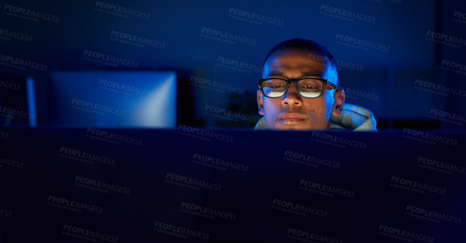 Buy stock photo Night, black man or hacker reading on computer for cybercrime, malware or phishing for stealing online data. Programmer, face and software update on pc for hacking scam or theft on website in dark  