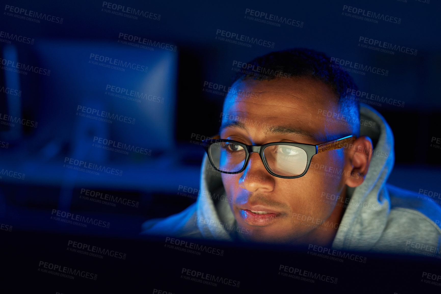 Buy stock photo Night, black man or hacker reading on laptop for cybercrime, malware or phishing for stealing online data. Programmer, face and software update on pc for hacking scam or theft on website in dark  