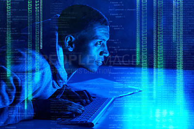 Buy stock photo Shot of a young male hacker cracking a computer code in the dark