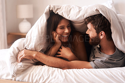 Buy stock photo Blanket, relax and couple with love, home and comfortable with joy, romance and loving together. Partners, man and happy woman in the bedroom, happiness and peace with a smile, romantic and bonding 