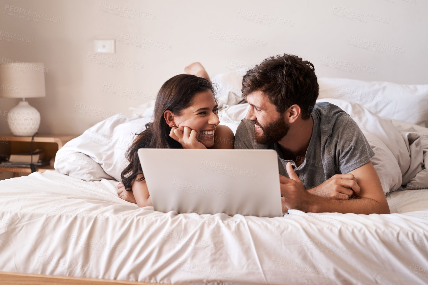 Buy stock photo Bed, laptop and happy couple relax, smile and excited for  for web info, morning blog or website notification. Home bedroom, eye contact and people bond, doing online shopping or internet search