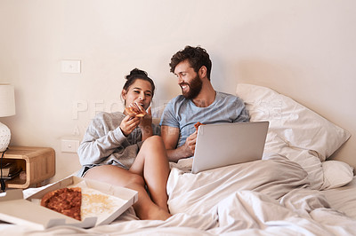 Buy stock photo Home bedroom, pizza and happy couple relax, laugh and eating fast food, takeout meal and watch online movie. Happiness, laptop or comfortable people smile, bond and enjoy quality time together on bed