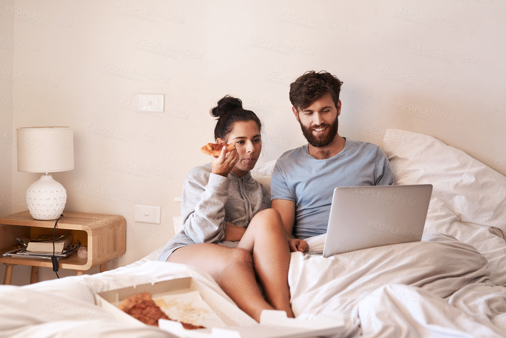 Buy stock photo Couple, pizza and movie on laptop in bed with junk food and streaming series. Eating, computer video and meal in a bedroom at home with man and woman together with bonding and online watching