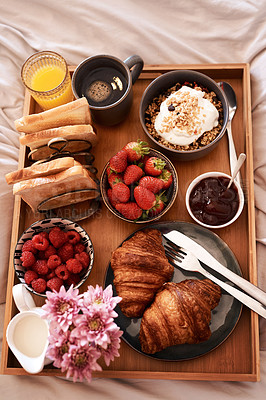 Buy stock photo Breakfast in bed, top view and morning food of croissant, strawberry and drinks for wellness, eating and home cuisine. Hospitality, hotel meal service and tray of bread, coffee and juice in bedroom