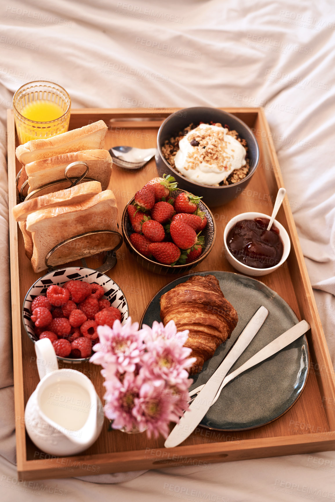 Buy stock photo High angle shot of a delicious breakfast spread on a bed at home
