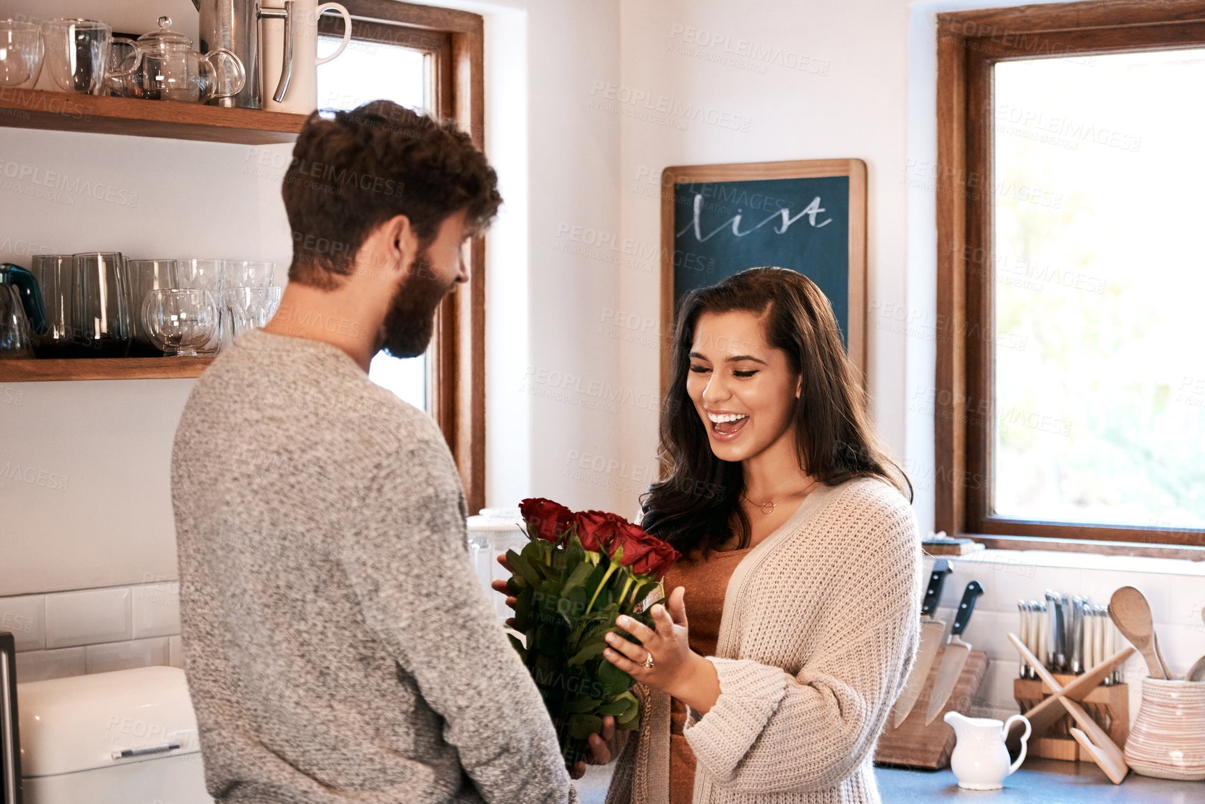 Buy stock photo Roses, kitchen and happy couple with surprise flowers, floral present and flower bouquet for Valentines Day celebration at home. Birthday, smile and romantic man with gift for marriage anniversary