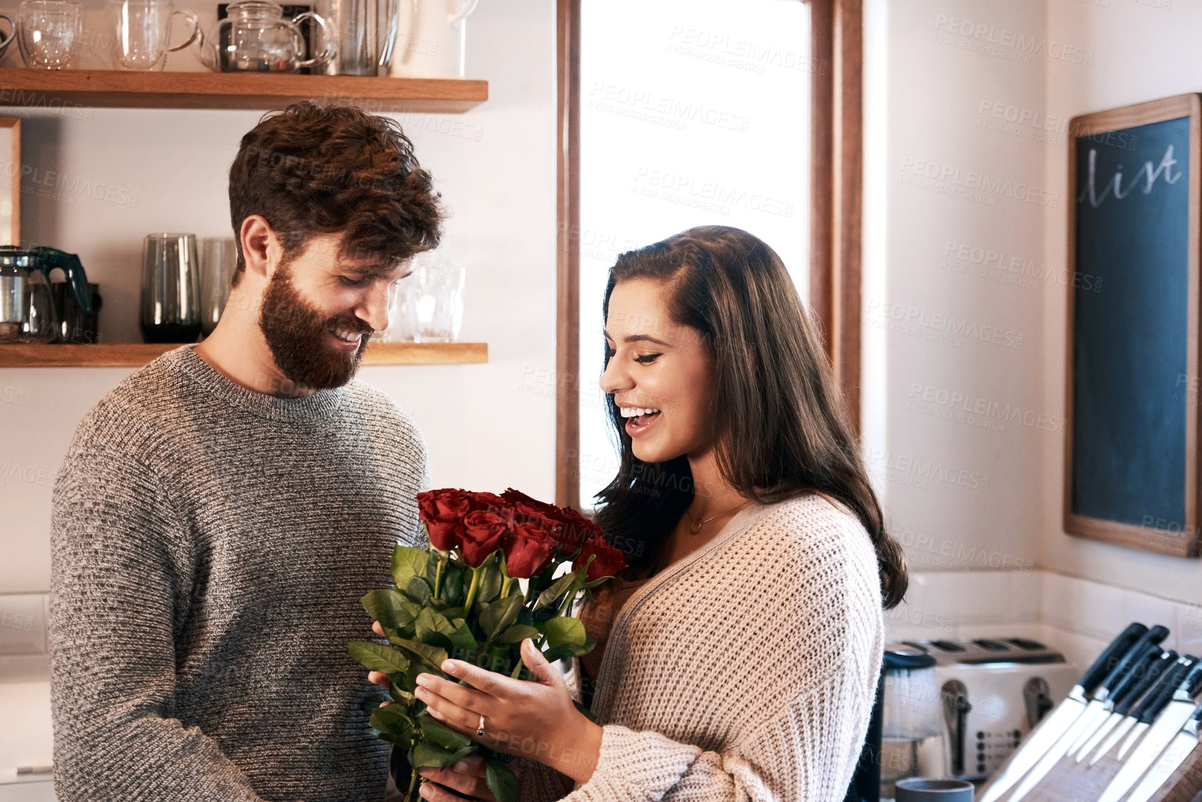 Buy stock photo Rose, surprise and happy couple with flowers, floral present or flower bouquet for Valentines Day in home kitchen. Birthday happiness, support and romantic man with love gift for marriage anniversary