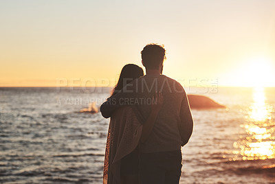 Buy stock photo Sunset, beach and couple hug by ocean in evening on holiday, summer vacation and weekend. Nature, love and man and woman embrace, hugging and relax for bonding, quality time and peace in evening