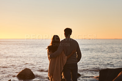 Buy stock photo Hug, sunset and couple relax on beach in evening on holiday, summer vacation and weekend by ocean. Nature, love and man and woman embrace, hugging and calm for bonding, quality time and peace by sea