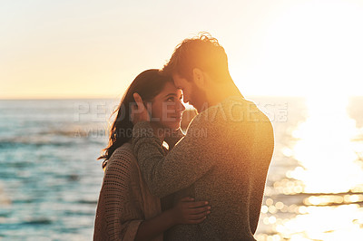 Buy stock photo Sunset, beach and couple touching face for relaxing, bonding and quality time on romantic date. Nature, love and man and woman embrace for anniversary or honeymoon on holiday, weekend and vacation