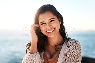 Buy stock photo Portrait of a happy young woman enjoying a day at the beach