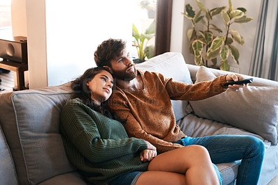 Buy stock photo Love, home and relax couple watching tv show, subscription movie or streaming entertainment in living room. Bond, media remote or marriage people watch television, film or video in apartment lounge