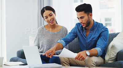 Buy stock photo Cropped shot of an happy young couple sitting on the sofa while using a laptop in their lounge
