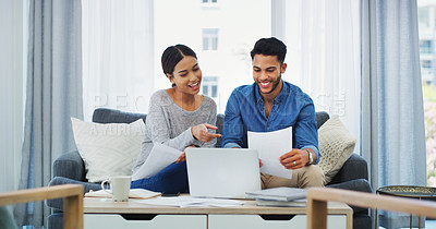 Buy stock photo Cropped shot of an happy young couple sitting on the sofa while using a laptop in their lounge