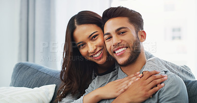 Buy stock photo Cropped portrait of an affectionate young couple cuddling with each other while in their living room during the day