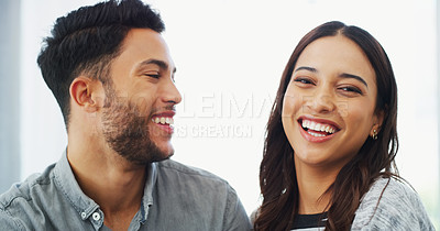 Buy stock photo Cropped headshot of a happy young couple sitting close to each other and smiling while indoors