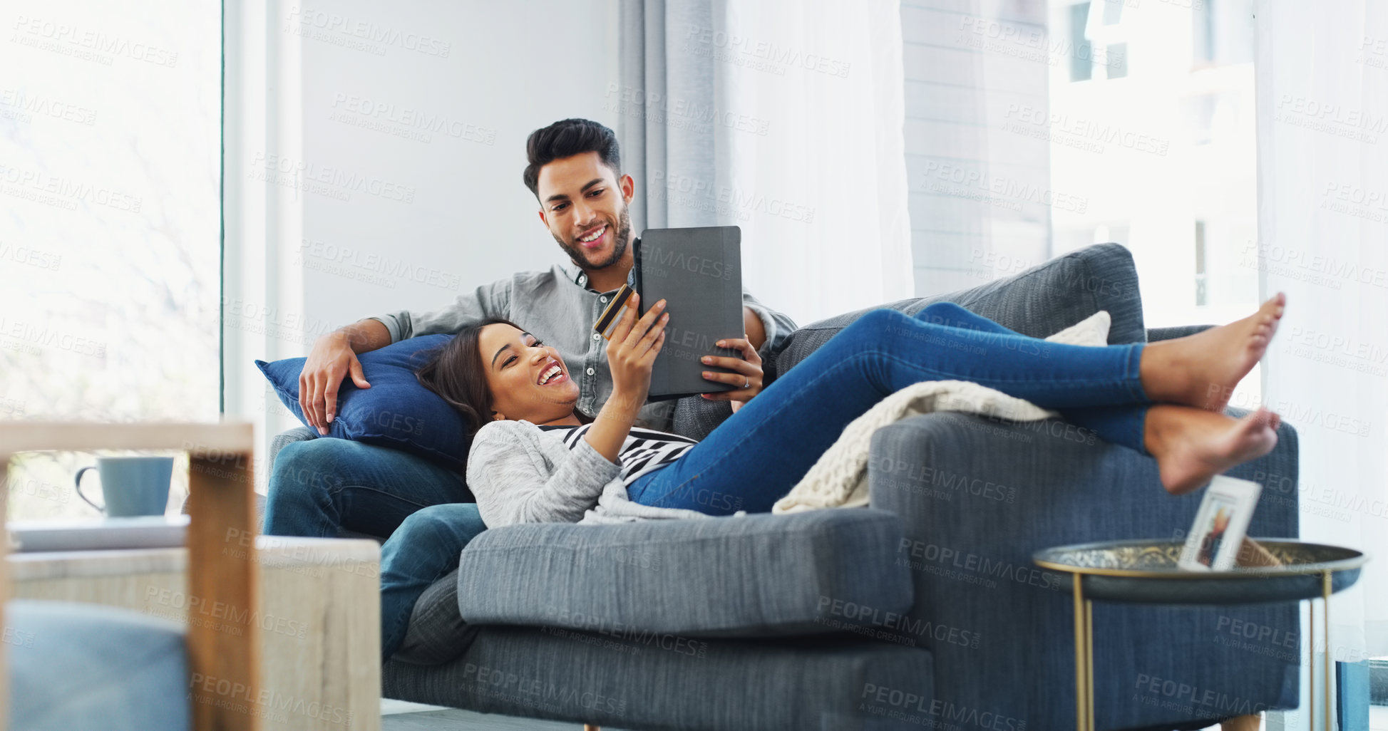 Buy stock photo Happy couple, relax and online shopping with tablet on sofa for virtual payment or banking in home. Man, woman or shoppers with smile, credit card or technology for ecommerce, order app or purchase