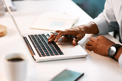 Buy stock photo Shot of an unrecognizable businessman working on his laptop during a late night shift at work