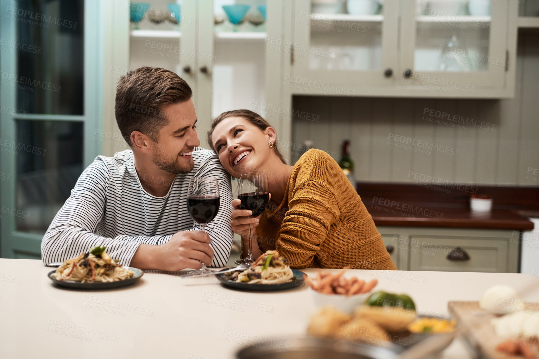 Buy stock photo Happy, couple and food in home with wine on date night for romance in relationship with bonding. Man, woman and together with dinner or alcohol in kitchen with love, trust and soul connection.