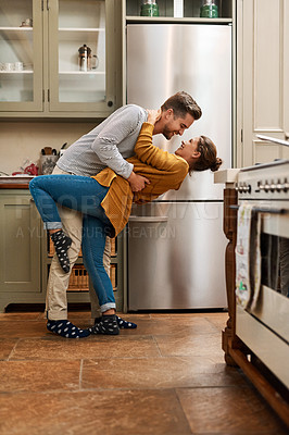 Buy stock photo Smile, couple and dancing with love in kitchen for bonding, romantic connection and sweet embrace for relationship. Man, woman and together in home with rhythm for affection, care and compassion.