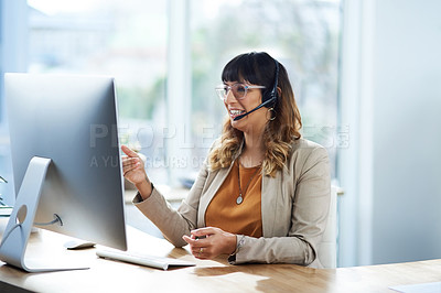 Buy stock photo Cropped shot of an attractive young businesswoman sitting and using a headset in her office during the day
