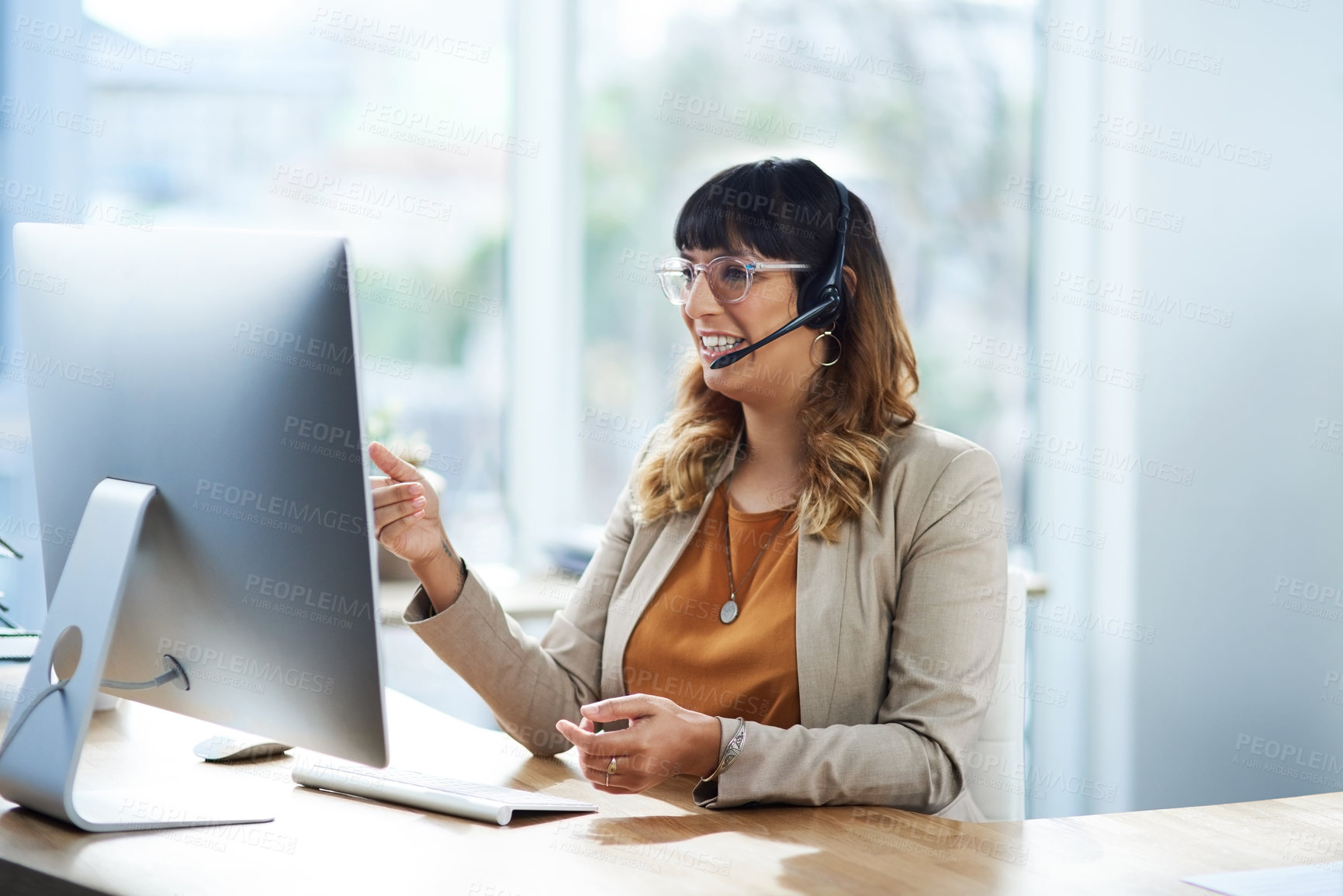 Buy stock photo Cropped shot of an attractive young businesswoman sitting and using a headset in her office during the day