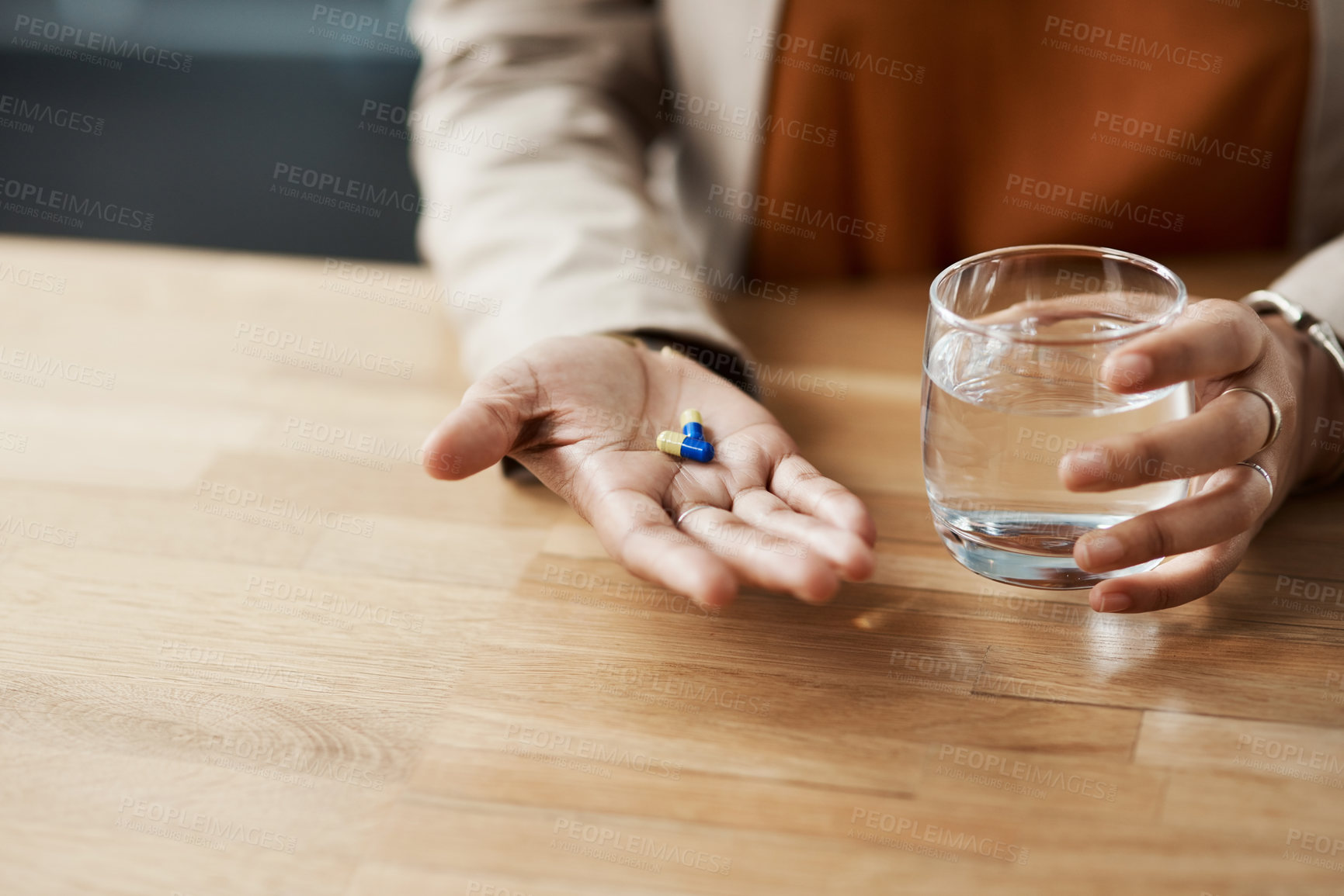 Buy stock photo Health, pills and hands of person with water, medication and dosage for treatment in office. Woman, glass and drugs on palm for prescription, supplement and vitamins for care or remedy of illness