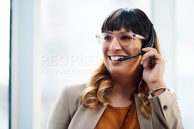 Buy stock photo Cropped shot of an attractive young businesswoman posing with her headset on while in her office during the day