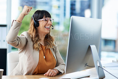 Buy stock photo Cropped shot of an attractive young businesswoman celebrating while wearing a headset in her office during the day
