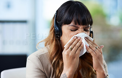 Buy stock photo Cropped shot of an attractive young businesswoman suffering from a cold and blowing her nose while in her office