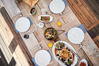 Buy stock photo High angle shot of a table setting with food and drinks outdoors