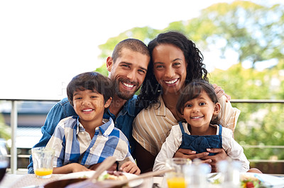 Buy stock photo Portrait of a beautiful young family enjoying a meal together outdoors
