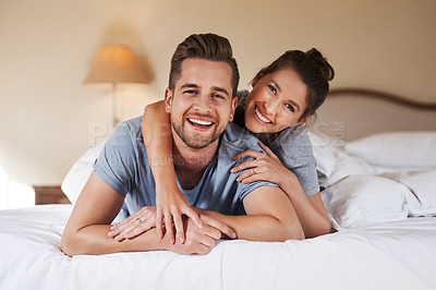 Buy stock photo Love, couple or happy on bed with portrait, hug or relax in hotel for travel. Luxury accommodation, man or woman in bedroom with trust, smile or honeymoon trip to resort with security and support