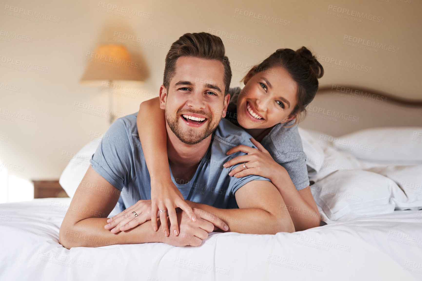 Buy stock photo Portrait of an affectionate young couple spending some quality time together in their bedroom at home