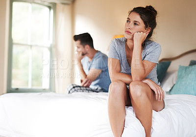 Buy stock photo Shot of a young couple having an argument in their bedroom at home