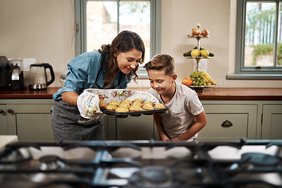 Buy stock photo Shot of a woman and her son baking together in the kitchen at home