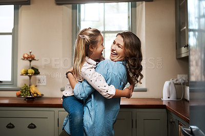 Buy stock photo Cropped shot of a young woman spending quality time at home with her daughter