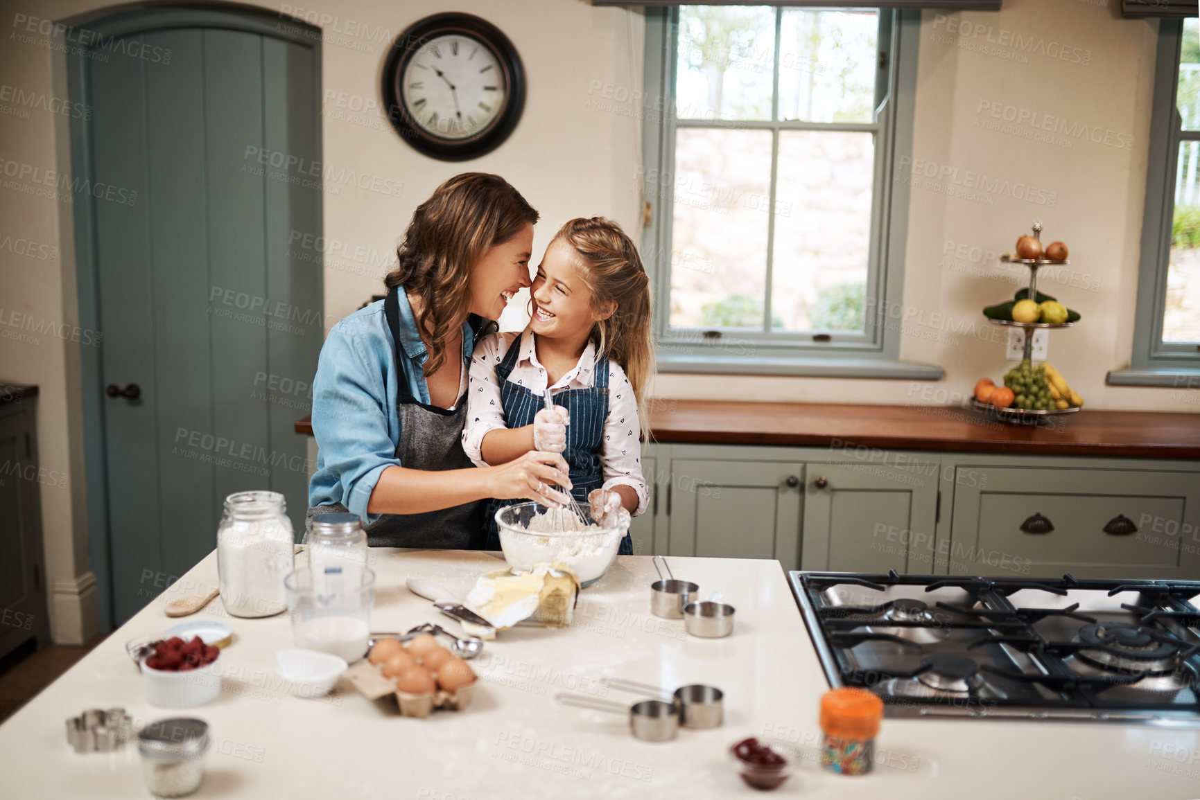 Buy stock photo Baking, mother and girl in kitchen, hug and ingredients with time together, hobby and support. Happy parent, mama or daughter with nutrition, learning and home with embrace, care and recipe with bowl