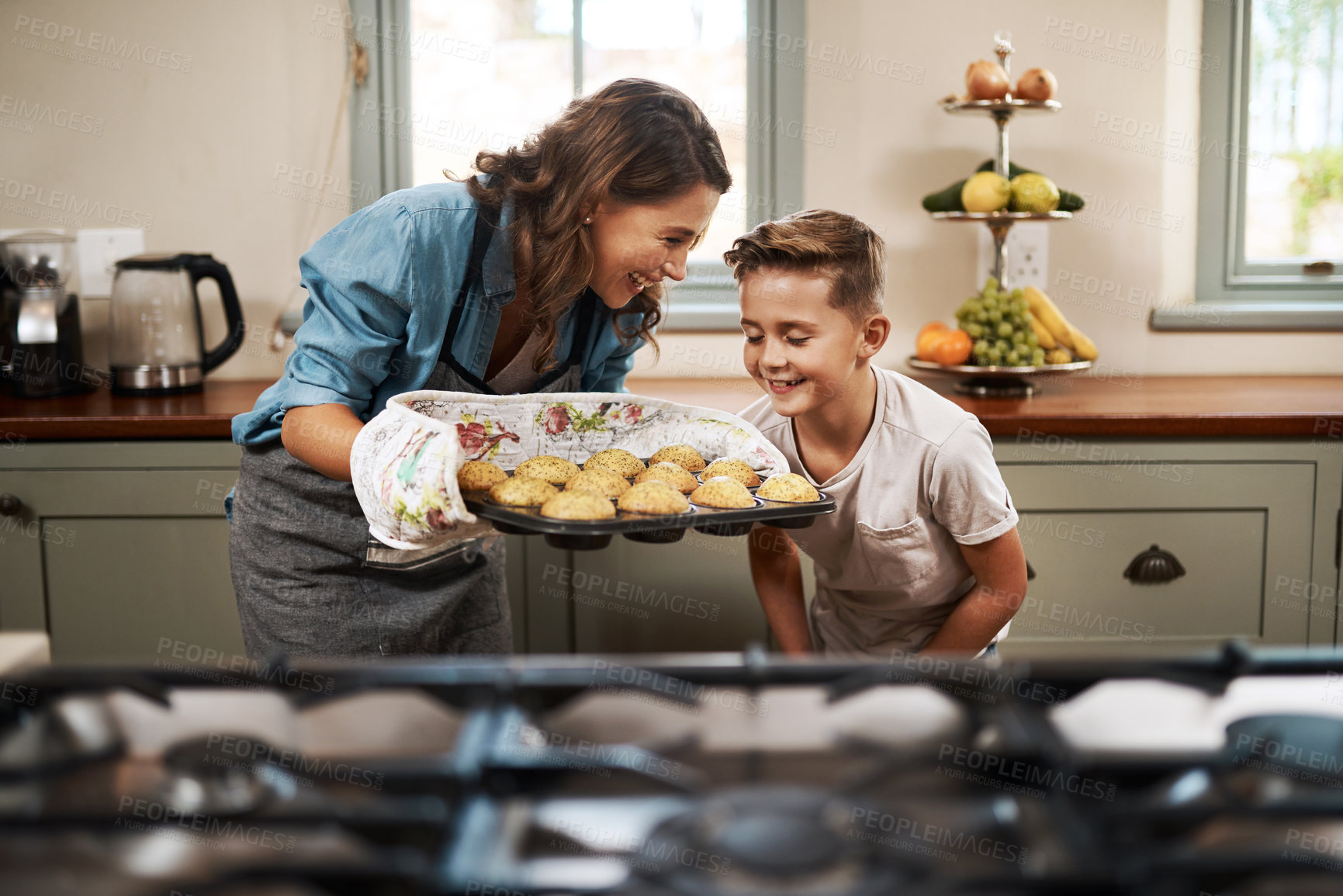 Buy stock photo Shot of a woman and her son baking together at home