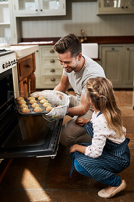 Buy stock photo Cropped shot of a young girl and her father baking at home