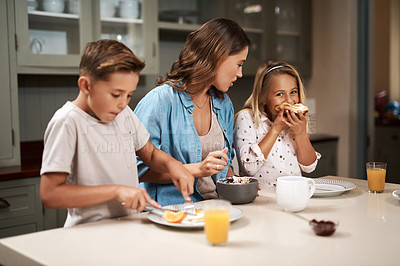 Buy stock photo Cropped shot of a young family having breakfast at home