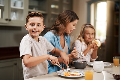Buy stock photo Cropped shot of a young family having breakfast at home