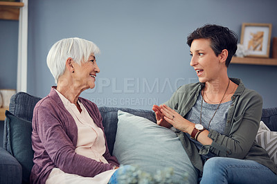 Buy stock photo Cropped shot of an affectionate  young woman having a conversation with her senior mother in their living room at home