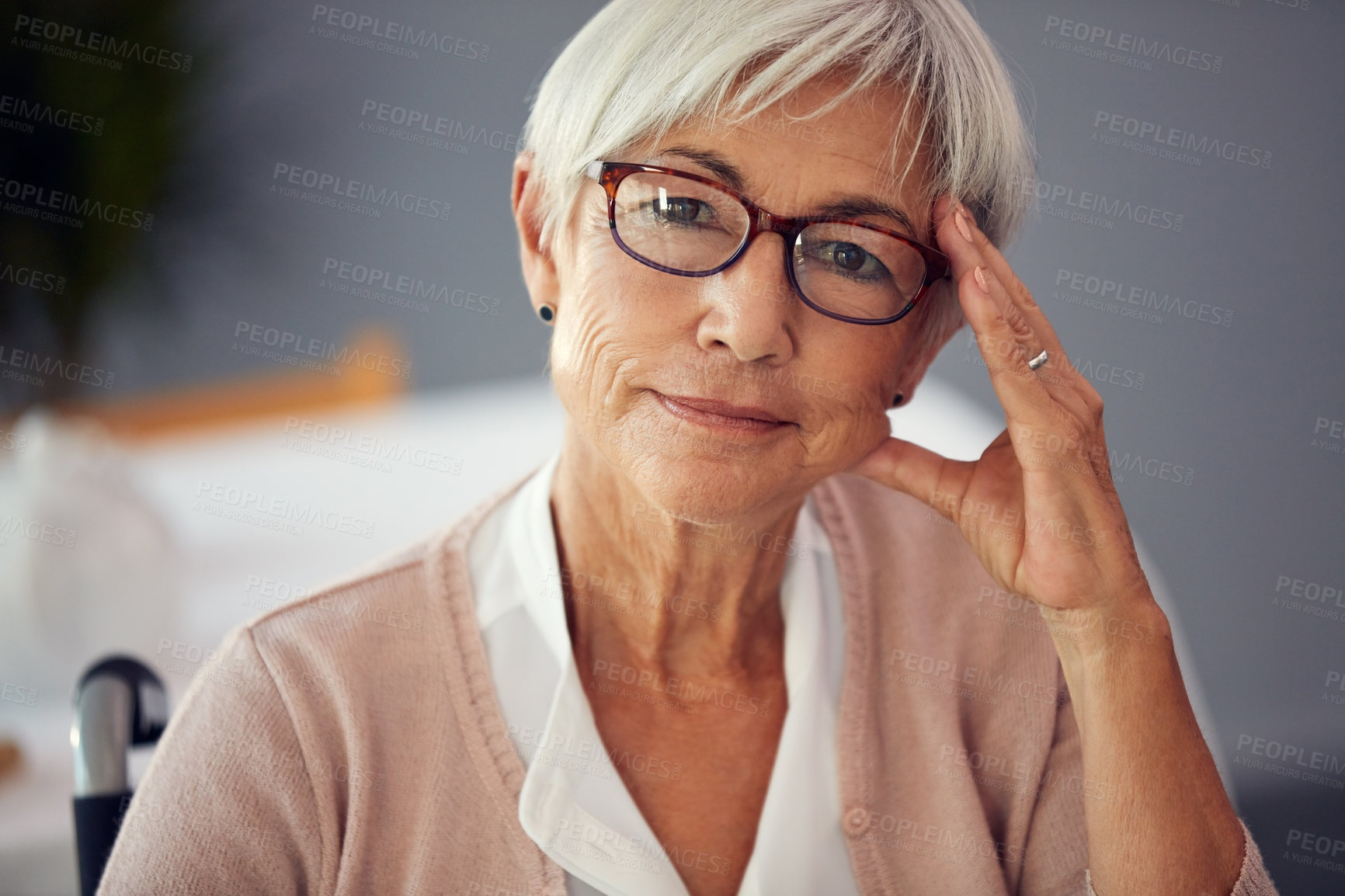 Buy stock photo Cropped portrait of a confident senior woman sitting in her wheelchair in a retirement home