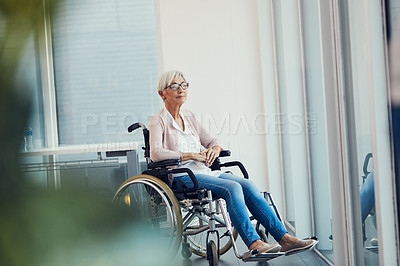 Buy stock photo Full length shot of a senior woman looking thoughtful while sitting in her wheelchair at a retirement home
